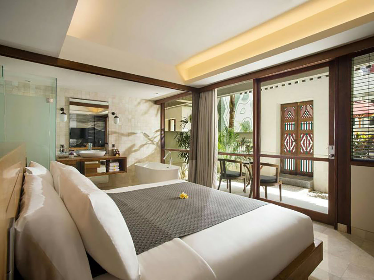 Single bed with deck and garden view at Amnaya Resort in Kuta, Bali