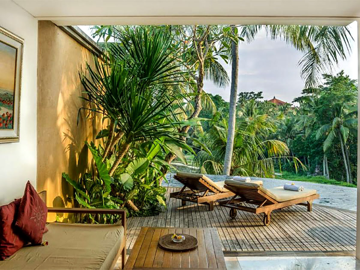 Deck chairs and scenic view of jungle at Motama Villa in Bali, Indonesia