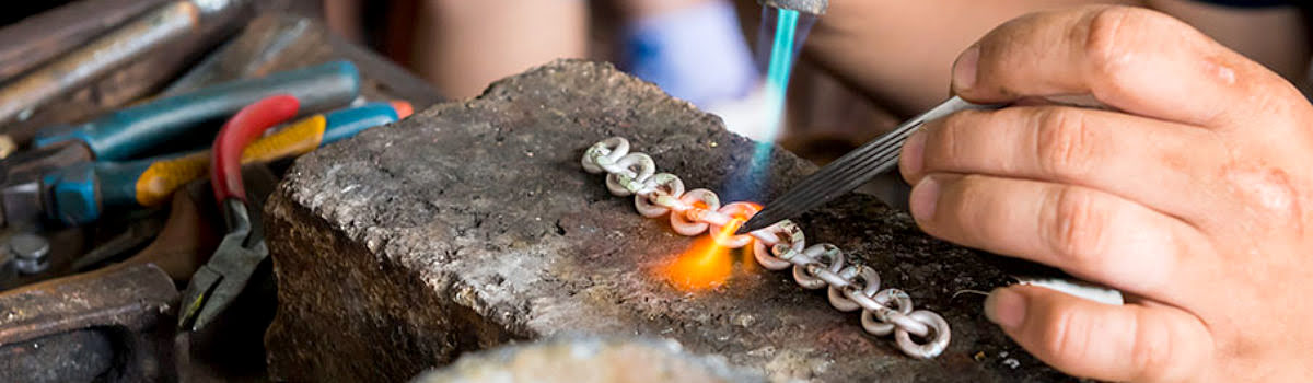 Blacksmith soldering traditional jewelry in Bali, Indonesia - featured image