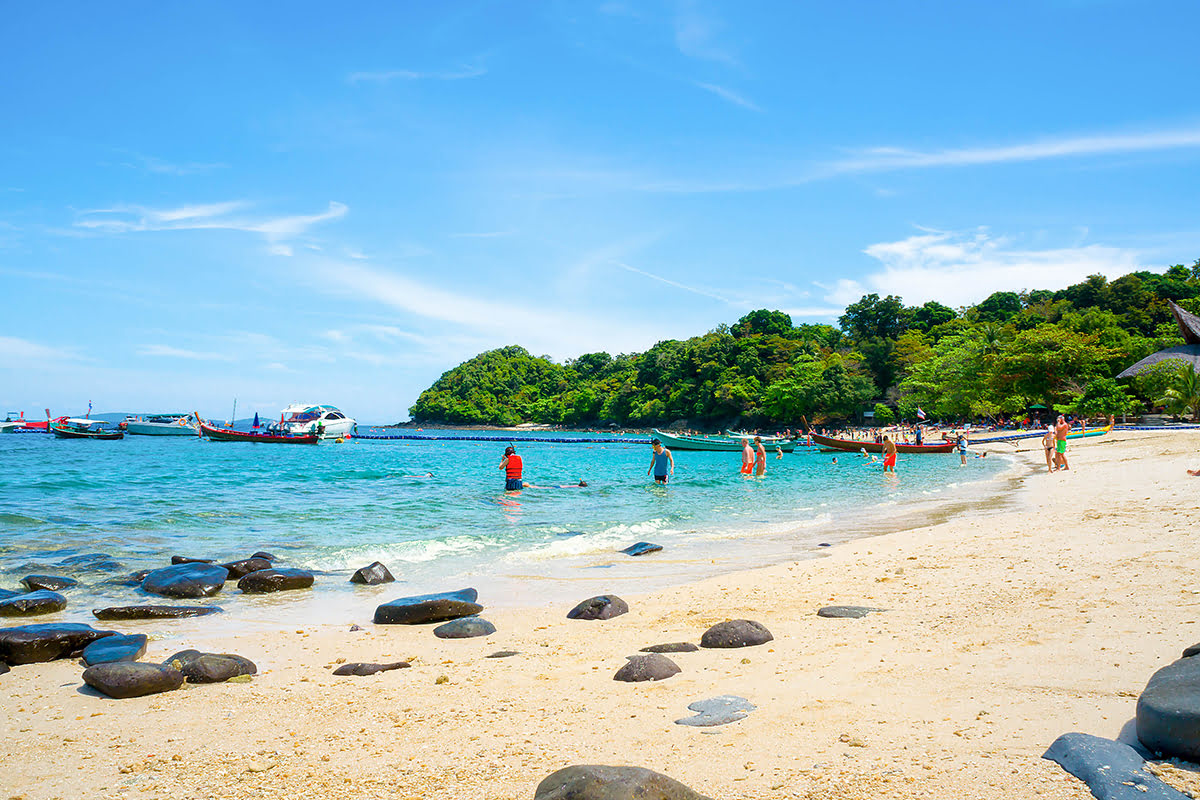 Coral island-Tourists on the beach