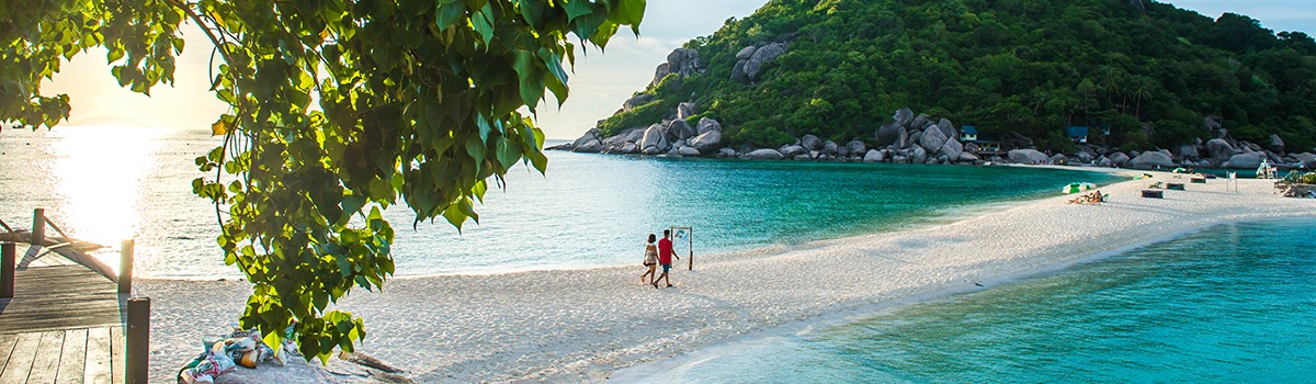 Two lovers hold their hand walking to the beach during sunset, Koh Nangyaun small island near Koh Tao, Koh Samui and Koh Phangan
