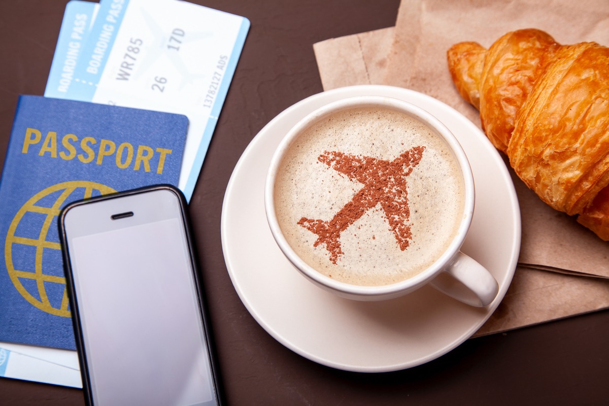 Mug of coffee with an airplane on the foam