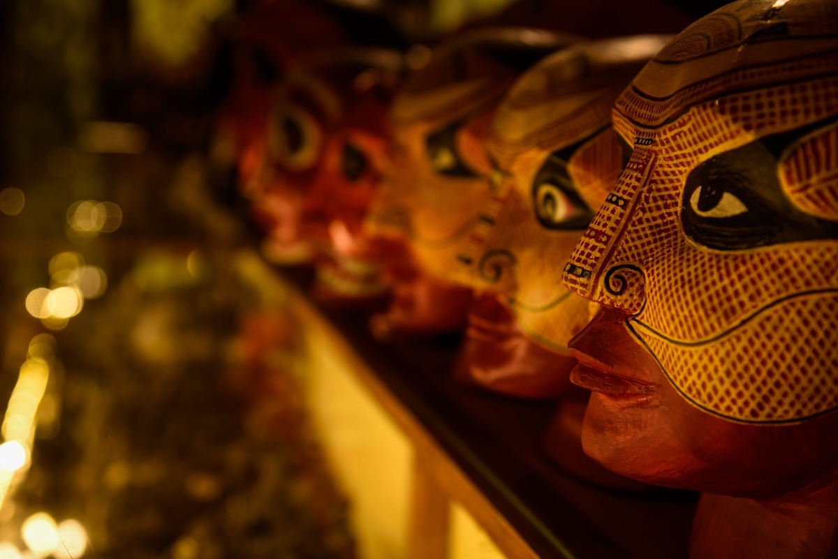 A series of Theyyam faces arranged at the Kerala Folklore Museum in Kochi, India
